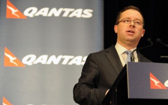 Qantas to slash jobs, cut costs as first-half profit slumps