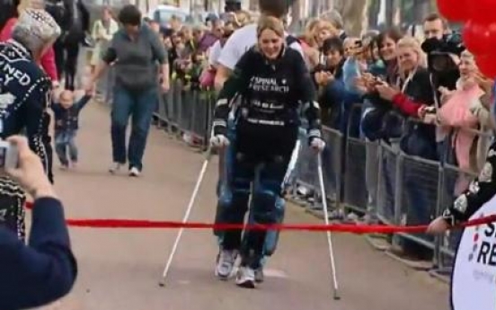 Paralyzed woman beats odds, completes marathon