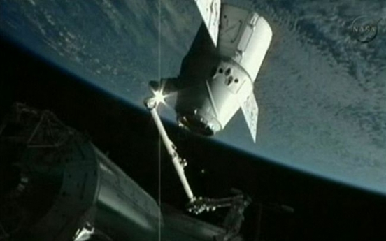 Dragon capsule docks at space station