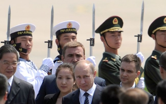 Putin in China to cement ties amid unity on Syria