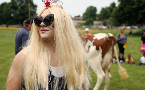 Principal dresses as Lady Gaga, milks cow for bet