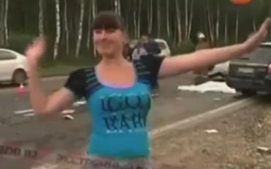 Shameful car passenger dances next to dead bodies