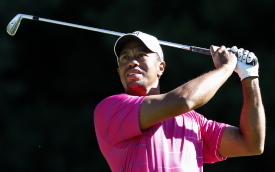 Woods tops $100 million in earnings