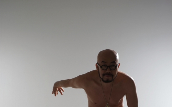 Fashion designer Lie Sang Bong poses nude