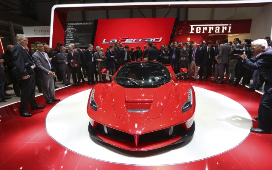 Ferrari, McLaren unveil hybrid supercars