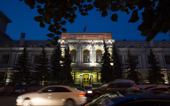 Russian central bank limits interventions, lets ruble float