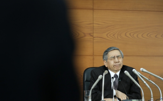 BOJ cuts inflation outlook, maintains record stimulus