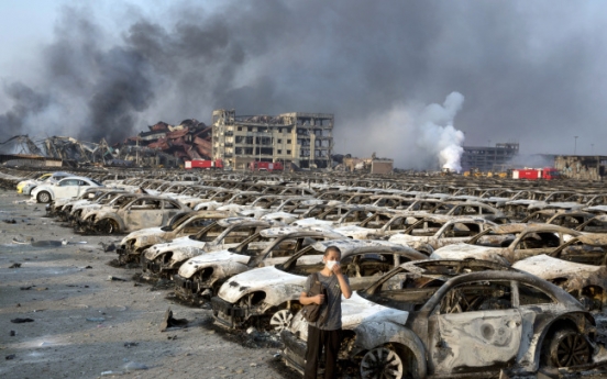 Firefighter rescued from blast zone in China's Tianjin port