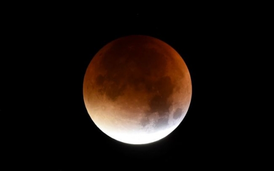 'Super blood moon' shines bright across the world