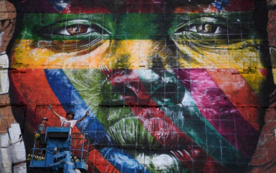 Brazil graffiti artist paints massive Olympic mural