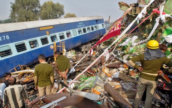 Train derails in north India, killing 104; many trapped