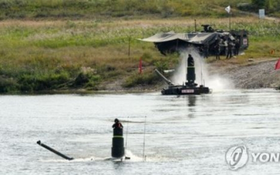 Submerged K-2 battle tanks cross river during exercise