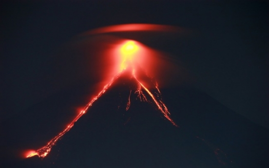 Glowing red lava causes more to flee from Philippine volcano