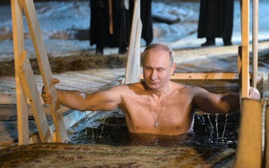 Putin takes dip in icy Russian lake on Epiphany