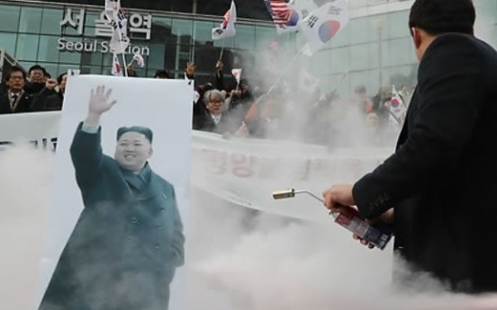 Protesters burn picture of NK leader in rally against Olympic participation