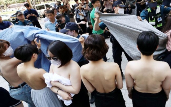 Feminist activists protest topless, Facebook Korea apologizes