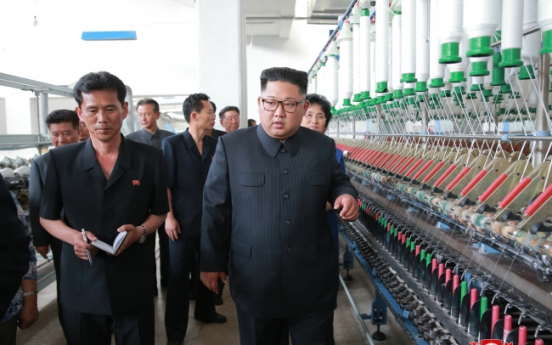 NK leader Kim visits textile plants, chastens workers for not working hard