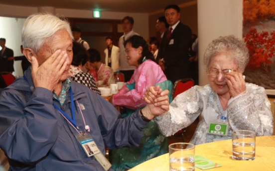 Separated families hold each other one last time