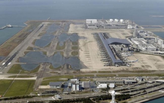 Stranded people leave flooded airport after typhoon in Japan