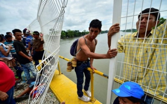 Mexico allows caravan women, children in, but thousands still stranded