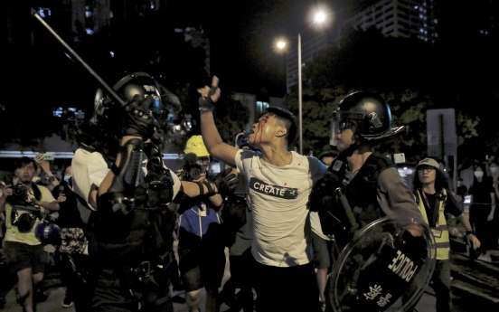 Clashes in Hong Kong after police charge protesters with rioting