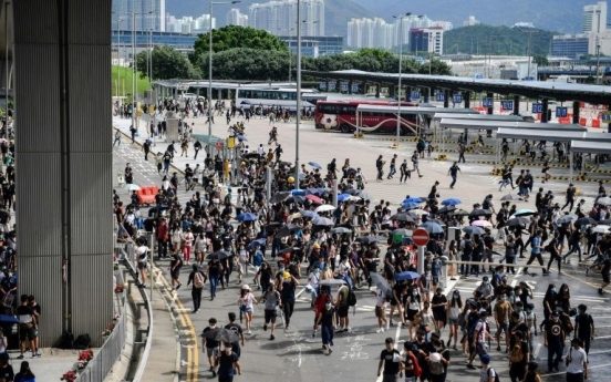 Hong Kong protesters target airport as city mops up