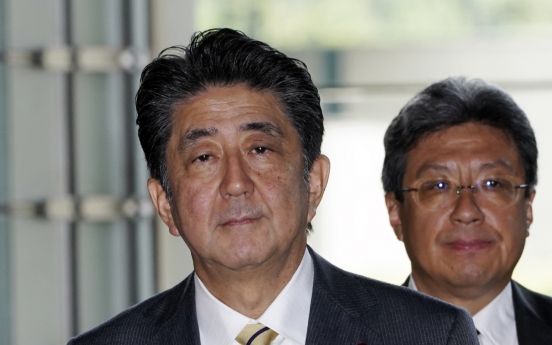 Japan's Abe shakes up cabinet, brings in rising star