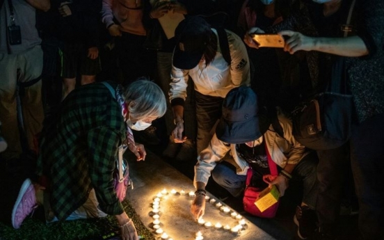 Huge Hong Kong rally after student dies and lawmakers arrested