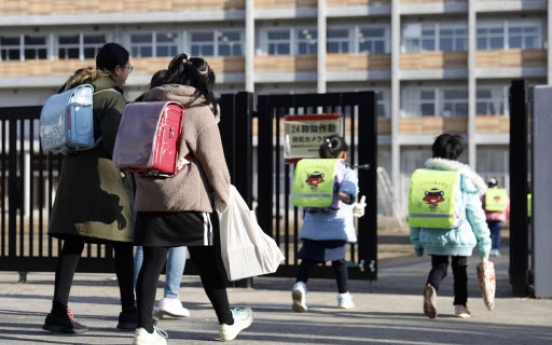 Japan PM defends school closure plan despite critics