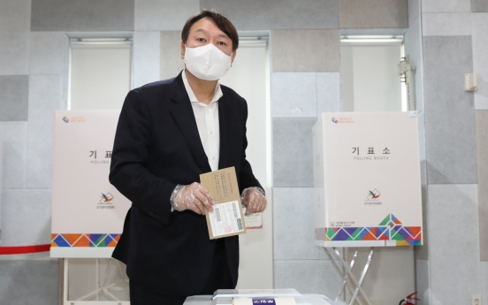 Yoon casts early ballot, fans speculations of political career