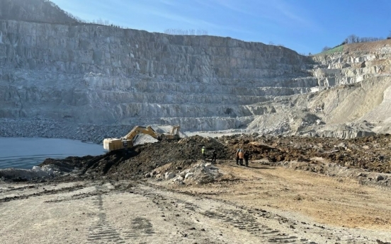 Rescuers retrieve one body, trying to find two buried workers in quarry