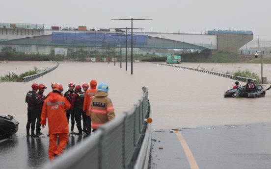 Rescuers desperately trying to reach people trapped in flooded tunnel