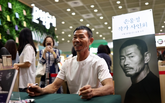 Son Woong-jung at book signing event amid child abuse allegations