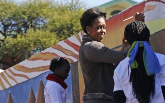 Michelle Obama helps paint mural at clinic in Botswana
