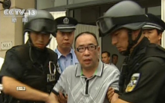 China’s No. 1 fugitive sent back after 12 years