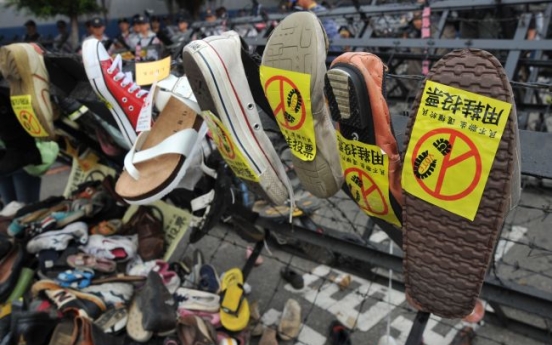 Protesters hurl shoes as Taiwan's ruling party meets