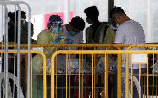Singapore extends coronavirus curbs as cases surge