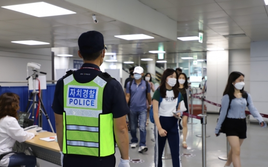 Police patrolling Jeju Airport to fight COVID-19 as more tourists visit the island