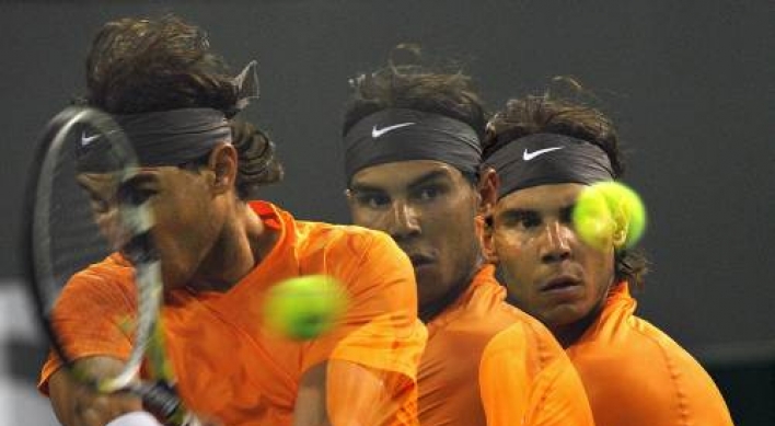 Nadal struggles but moves on
