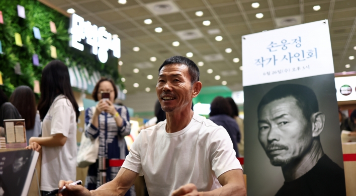 Son Woong-jung at book signing event amid child abuse allegations