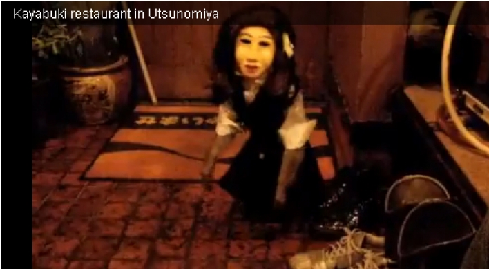 Waitress monkey wearing a ‘Japanese doll’ mask still a massive hit on YouTube