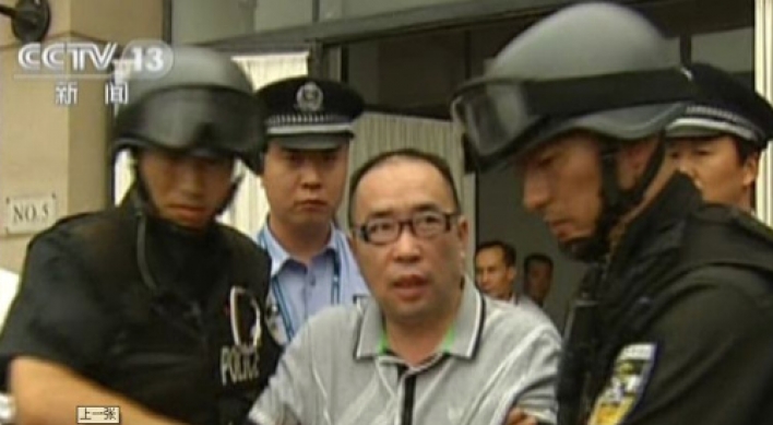 China’s No. 1 fugitive sent back after 12 years
