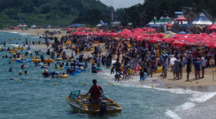 Vacationers swim, sunbathe at provincial beach
