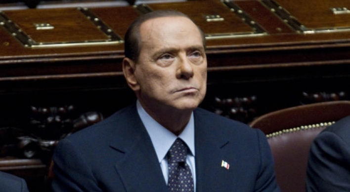 Defiant Berlusconi taken down by markets