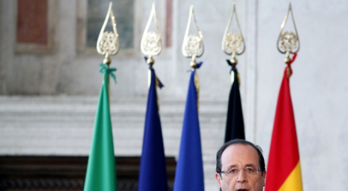 Hollande vows to defend eurozone