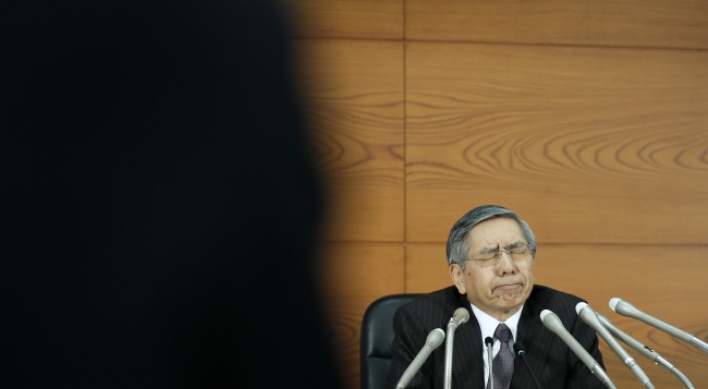 BOJ cuts inflation outlook, maintains record stimulus