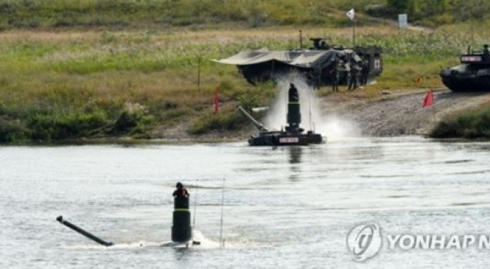 Submerged K-2 battle tanks cross river during exercise