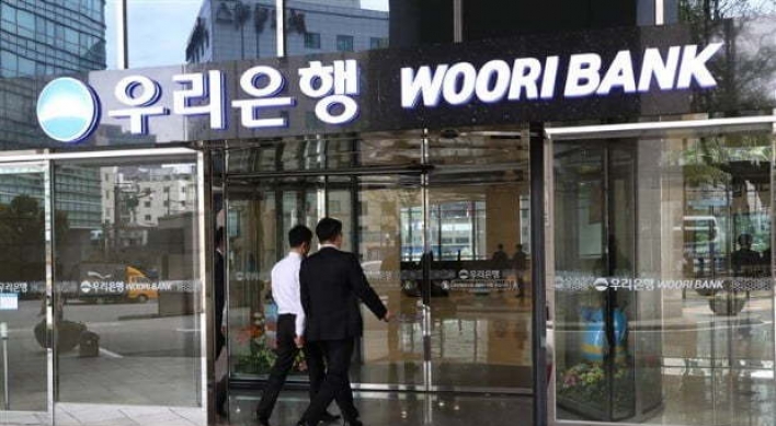 [News Focus] Government offloading Woori stakes to elevate holding company