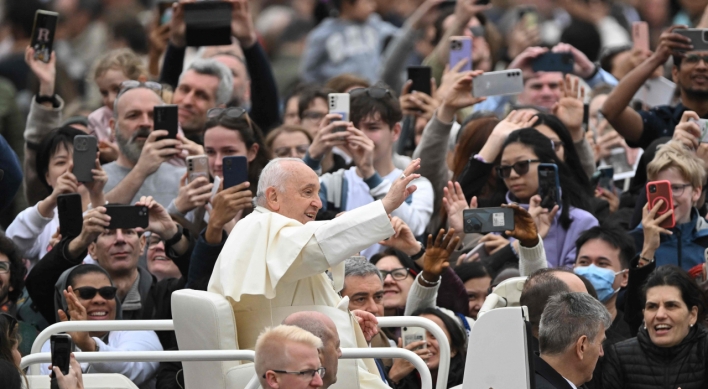 Pope overcomes health concerns to preside over a blustery Easter Sunday Mass in St. Peter's Square