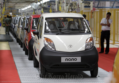 Tata Motors Ltd. Nano vehicles are parked in a line at the company’s plant in Sanand Taluka, India. (Bloomberg)
